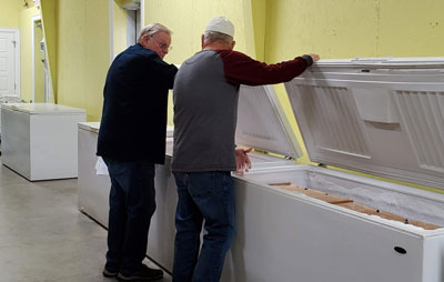 Volunteers inspect freezers